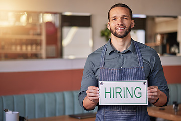 Image showing Recruitment, portrait or man with a hiring sign for job vacancy offer in cafe or small business store. Hospitality, labour shortage or happy entrepreneur smile with an onboarding message to hire