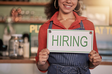 Image showing Small business, hands or black woman with a hiring sign for job vacancy offer in cafe or coffee shop. Recruitment, marketing or happy entrepreneur smiles with an onborading message in store