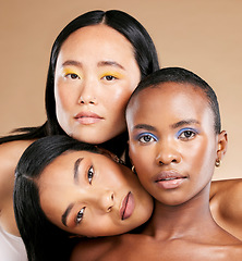 Image showing Diversity, woman and focus face with makeup, skincare beauty and cosmetics dermatology in brown background studio. Interracial models, facial care and support together for natural glowing skin