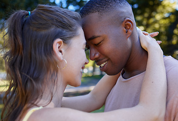 Image showing Love, park and face with an interracial couple bonding or hugging outdoor together on a romantic date in nature. Summer, romance and diversity with a man and woman dating outside in a green garden