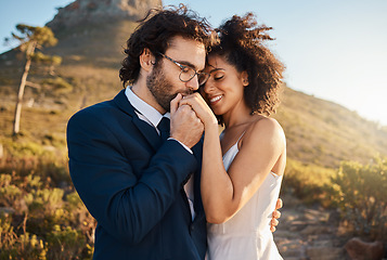 Image showing Love, kiss and wedding with couple in nature for celebration, happiness and romance. Sunset, hug and affectionate with bride and groom in embrace at countryside for happy, marriage and smile together