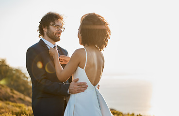 Image showing Wedding, couple and bride with groom by ocean for marriage ceremony, commitment and celebration. Romance, love and interracial man and woman bonding, happy and smile on mountain, nature and outdoors