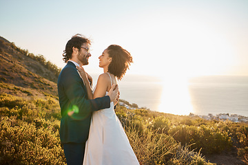 Image showing Wedding, love and couple on mountain for marriage ceremony, commitment and celebration. Romance, happiness and interracial bride and groom bonding, share intimate moment and smile by ocean in Italy