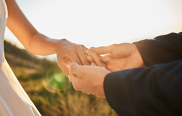 Image showing Couple hands, wedding ring and marriage trust, hope and love together in nature outdoor. Bride, groom and save the date event, support and jewellery for celebration, relationship solidarity and unity