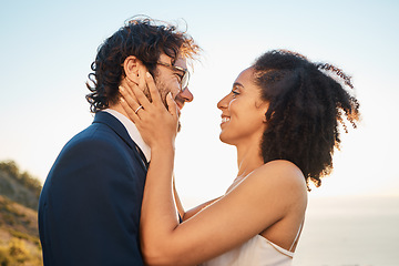 Image showing Wedding, love and interracial couple on mountain for marriage ceremony, commitment and celebration by sea. Romantic holiday, happy and bride and groom bonding, hug and smile by ocean with sunset