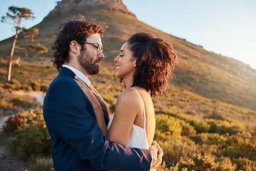 Image showing Love, wedding and bride and groom on mountain for marriage ceremony, commitment and celebration. Trust, happy and interracial couple bonding, hug and smile on romantic holiday, vacation and honeymoon