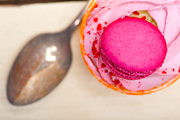 Image showing pink berry cream cupcake with macaroon on top