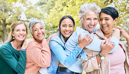 Image showing Friends, park and group of women hug enjoying bonding, quality time and relax in nature together. Diversity, friendship and portrait of happy senior females with smile, embrace and peace outdoors