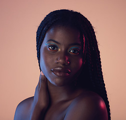 Image showing Portrait, hair and beauty with a model black woman in studio on a wall background for natural haircare. Face, makeup and braids with an attractive young female posing to promote keratin treatment