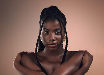 Image showing Portrait, hair and braids with a model black woman in studio on a wall background for natural haircare. Face, beauty and makeup with an attractive young female posing to promote cosmetics