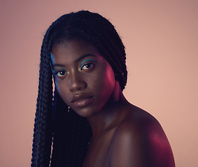 Image showing Portrait, face and hair with a model black woman in studio on a wall background for natural haircare. Makeup, beauty and braids with an attractive young female posing to promote keratin treatment