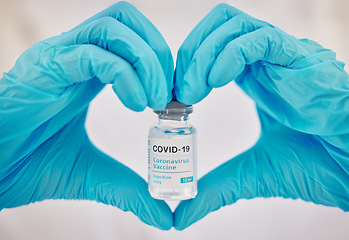 Image showing Covid 19 vaccine, doctor hands and love emoji gesture for healthcare support, medical wellness and safety security medicine. Hospital pharmacy, nurse or pharmacist with vial for immunity vaccination