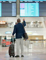 Image showing Travel, airport or black man pointing at screen with suitcase or luggage at customs in New York city. Back view, airplane or African businessman checks international flight transportation time delay