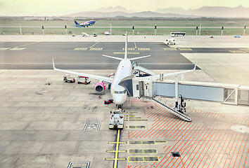 Image showing Airport, travel and airplane loading cargo for takeoff, international flight and commercial transportation. Air transport, global destination and plane on runaway to pack baggage or luggage