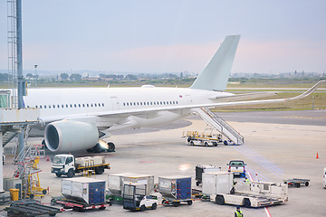 Image showing Travel, airport and cargo on airplane for flight, international takeoff and commercial transportation. Air transport, global destination and plane on runaway loading baggage, boarding and luggage