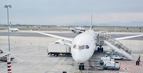 Image showing Airport runway, global travel and airplane ready for takeoff, international flight and commercial transportation. Air transport, journey and plane at terminal loading cargo, baggage and luggage
