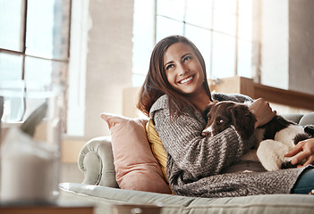 Image showing Woman relax on couch with dog, smile and content at home with pet and happy together with peace in living room. Happiness, love for animals and care with female and puppy, cuddle on sofa in apartment