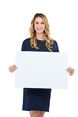 Image showing Woman holding a sign or poster marketing and advertising a brand with a mock up isolated in a studio white background. Portrait of a happy and smiling person showing a board or space for a sale