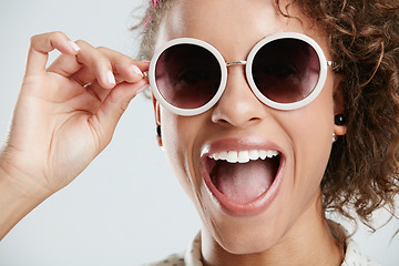 Image showing Beauty, sunglasses and face of woman with smile on white background for summer, casual and trendy style. Creative, accessory and zoom of excited girl in studio with cosmetics, makeup and confidence