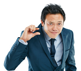 Image showing Portrait, hand or small with a business asian man in studio isolated on a white background to measure size. Face, gesture or little and a male employee giving a review or feedback with a finger scale