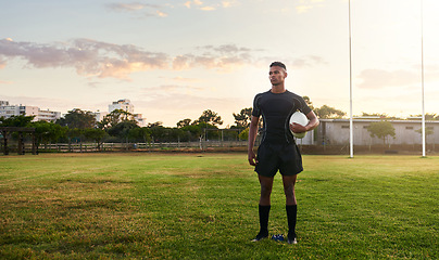 Image showing Rugby player, sports and standing on field with ball ready for game, match or practice outdoors. Sporty man athlete or professional waiting for rugby competition, training or play time on green grass