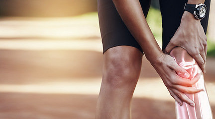 Image showing Hands, knee and injury with a sports man holding his joint in pain after suffering an accident while running outdoor. Fitness, exercise or training and a male athlete struggling with an injured leg