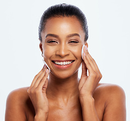 Image showing Black woman, beauty and cotton on face portrait in studio for dermatology, cosmetics and natural skin. Happy aesthetic model cleaning makeup for self care facial glow isolated on a white background