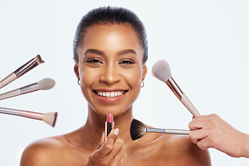 Image showing Makeup, beauty brush and lipstick on face of woman portrait in studio for dermatology cosmetics. Happy aesthetic model person with facial tools for healthy skin glow isolated on a white background