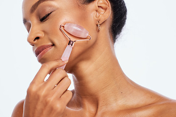 Image showing Beauty, jade roller and massage for a woman in studio for dermatology, skincare and natural skin. Aesthetic model person with facial stone tools for healthy glow isolated on a white background