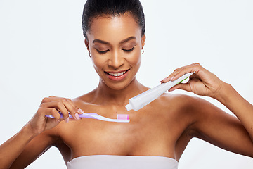 Image showing Dental hygiene, grooming and woman brushing teeth isolated on white background in a studio. Health, cleaning and model with toothpaste and a toothbrush for a healthy mouth and oral care on a backdrop