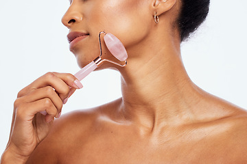 Image showing Skincare, beauty and woman with jade roller for her face isolated on a white background in studio. Massage, wellness and cosmetics model with facial care, grooming and relaxing treatment on backdrop