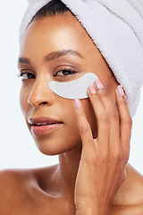 Image showing Spa eye patch, skincare and beauty of a woman portrait in studio for dermatology. Aesthetic model for spa facial, towel and healthy or natural face glow, hand on cosmetic isolated on white background