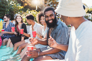 Image showing Vacation, drinks and friends speaking in a pool at a summer party, celebration or event at a home. Diversity, happy and people talking, having fun and bonding by the swimming pool while drinking.