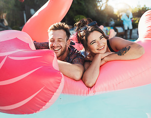 Image showing Pool party, portrait and happy couple floating in the water together while on vacation at a resort. Float, summer and young man and woman in a swimming pool having fun on a holiday or weekend trip.