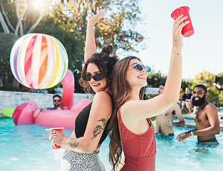 Image showing Fun, drink and portrait of friends at a pool party for swimming, celebration and vacation in summer. Playful, alcohol and women in the water on a tropical group holiday for a break to celebrate life