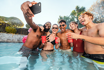 Image showing Selfie, beer and friends at pool party having fun on new years. Swimming celebration, water event and group of happy people with tongue out, peace sign and taking pictures for social media in summer.