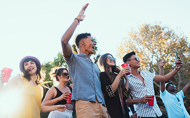 Image showing Drinks, party and a crowd of friends outdoor to celebrate at festival, concert or summer social event. Diversity young men and women people together while dancing, happy and excited with alcohol