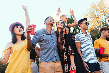 Image showing Drinks, party and a couple of friends dancing outdoor to celebrate at festival, concert or social event. Diversity young men and women people together while happy, singing and drinking alcohol