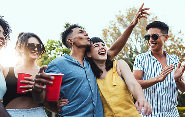 Image showing Drinks, party and a couple of friends dancing outdoor to celebrate at festival, concert or social event. Diversity young men and women people together in summer, happy and drinking alcohol in crowd