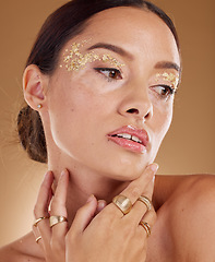 Image showing Face cosmetics, facial glitter and woman with luxury gold eyeshadow, beauty product and skincare glow. Makeup, spa salon or aesthetic model girl with jewelry ring, accessories and healthcare wellness