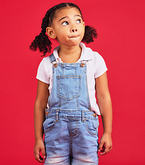 Image showing Thinking, girl and red studio background of an isolated young child with an idea and casual fashion. Relax, youth ideas and calm child feeling curious alone with denim dungarees of cute kid