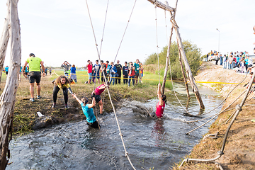 Image showing Athletes go through mud and water