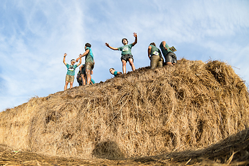 Image showing Athletes overcoming the hay osbtacle