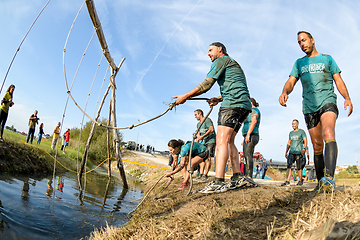 Image showing Athletes go through mud and water