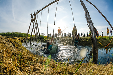 Image showing Athletes go through mud and water