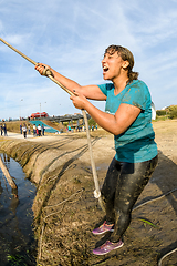 Image showing Athlete go through mud and water