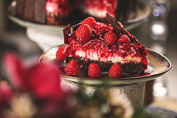 Image showing Slice of chocolate cake with raspberries