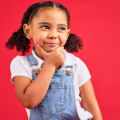 Image showing Little girl, face or thinking hand on chin on isolated red background in games innovation, studio question or fun vision. Smile, happy or curious child with ideas, fashion clothes or curly hair style