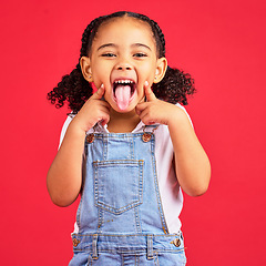 Image showing Little girl, portrait and tongue out on isolated red background in goofy, silly games and playful facial expression. Happy, kid and child with funny face in comic emoji, charades and studio activity