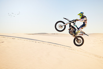 Image showing Motorcycle, desert race and air jump for extreme sport expert with agile speed, power or balance in nature. Motorbike man, rally and blue sky on fast vehicle with helmet, safety clothes or motivation